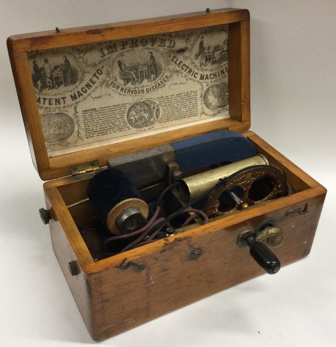 An old wooden cased shock machine. Est. £50 - £80.
