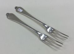 A rare pair of George I silver three prong forks w