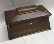 A large rosewood tea caddy of shaped form to hinge