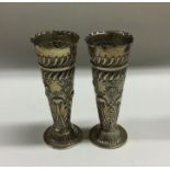 A pair of tapering silver embossed spill vases. Lo