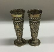 A pair of tapering silver embossed spill vases. Lo