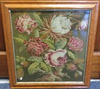 A maple framed and glazed tapestry depicting flowe