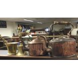 Two copper kettles together with a brass pestle an