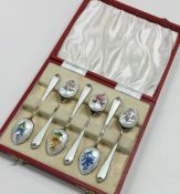 A boxed set of six silver and enamelled teaspoons.