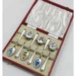 A boxed set of six silver and enamelled teaspoons.