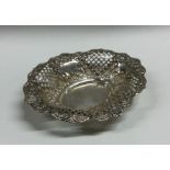 An Edwardian silver embossed bonbon dish with flor