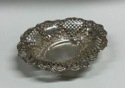 An Edwardian silver embossed bonbon dish with flor