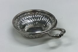 A heavy French silver wine taster with half fluted
