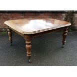 A good mahogany extending table on turned supports