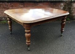 A good mahogany extending table on turned supports