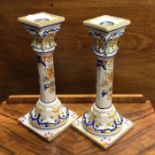 A pair of decorative Continental pottery candlesti