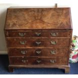 A good burr walnut veneer four drawer fall flap bureau with oak sides. E