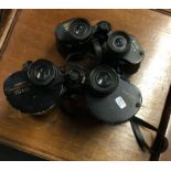 Two pairs of cased binoculars. Est. £20 - £30.
