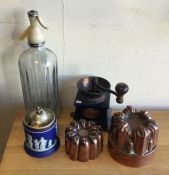 A cast iron coffee grinder together with copper je