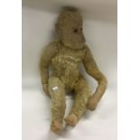 An old child's toy monkey. Est. £10 - £20.