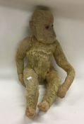 An old child's toy monkey. Est. £10 - £20.