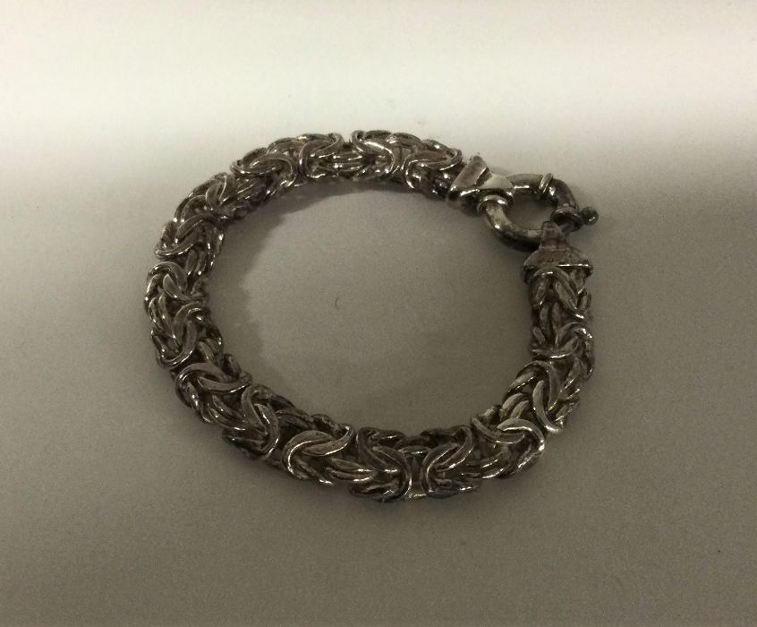 A heavy silver pierced bracelet with ring clasp. A