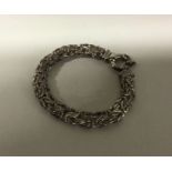A heavy silver pierced bracelet with ring clasp. A