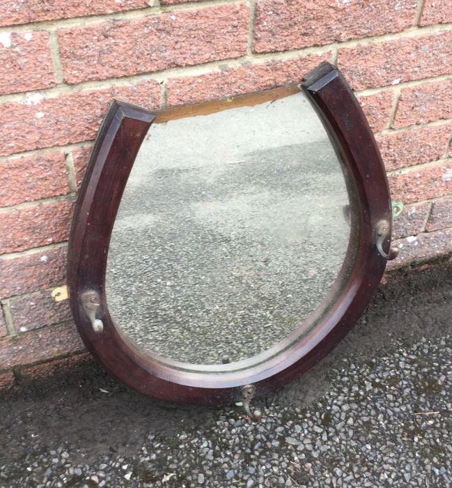 An oak framed mirror in the form of a horseshoe. E