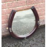 An oak framed mirror in the form of a horseshoe. E