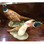 Two Beswick figures of pheasants. Est. £15 - £20.