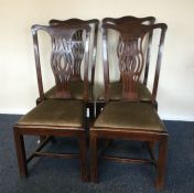 A set of four mahogany chairs with slip-in seats.