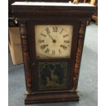 An old mahogany cased wall clock. Est. £30 - £50.