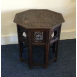 A carved Moroccan occasional table of shaped form.