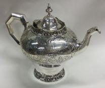 A fantastic Victorian silver teapot with cast bord