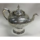 A fantastic Victorian silver teapot with cast bord