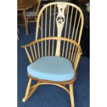 ERCOL: A slat back rocking chair. Est. £50 - £80.