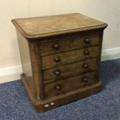 A figured walnut five drawer apprentice chest. Est