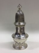 A heavy silver sugar caster with pierced decoratio