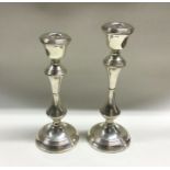 A pair of tapering silver candlesticks with reeded