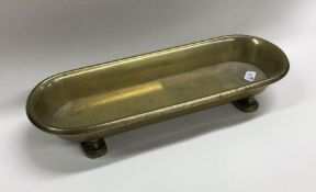 A heavy boat shaped brass pen tray of Chinese desi