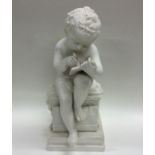 An unusual white pottery figure of a child on squa