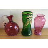 A cranberry glass vase together with other coloure