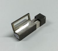 An unusual engine turned silver lipstick holder. A