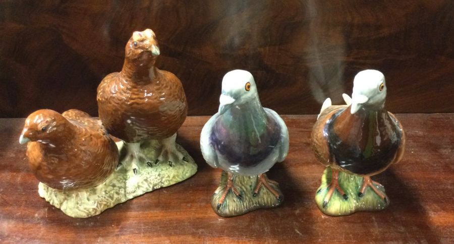 Two Beswick figures of pigeons together with two g