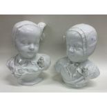 A pair of white pottery busts of children. Est. £2