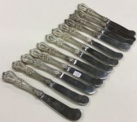 A good set of twelve chased silver handled butter