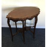An Edwardian occasional table of shaped form. Est.