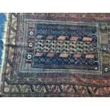 A small Indian rug decorated in bright colours. Es