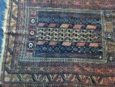 A small Indian rug decorated in bright colours. Es