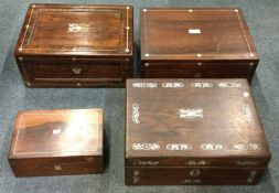 A group of four rosewood inlaid caddies. Est. £30