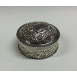 A chased silver and embossed box with lift-off cov