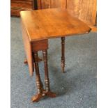 An Edwardian Sutherland table on turned supports.