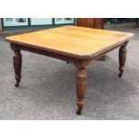 A good Edwardian satinwood extending table on reed