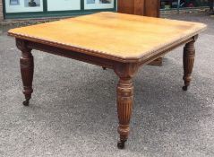 A good Edwardian satinwood extending table on reed