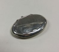 A small oval silver hinged top compact. Est. £20 -